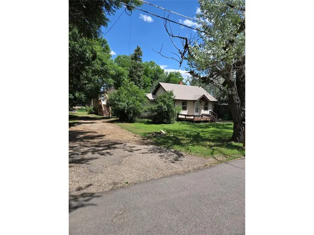 a view of a house with a yard and pathway