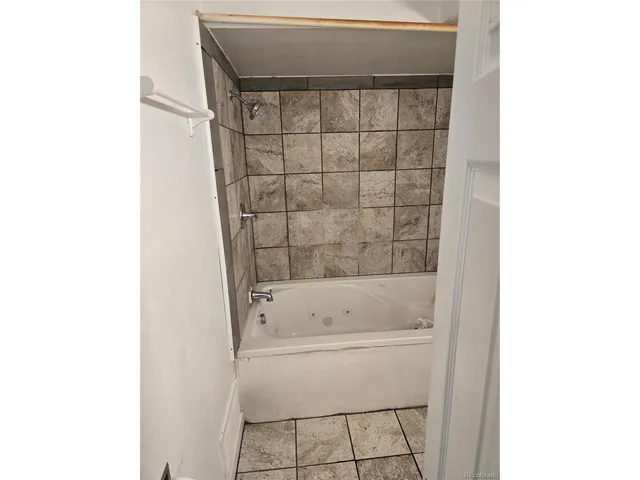 a bathroom with a bathtub and shower