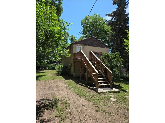 a view of a house with a yard and garage