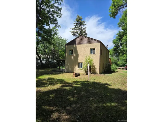 a view of a house with a yard balcony and sitting area