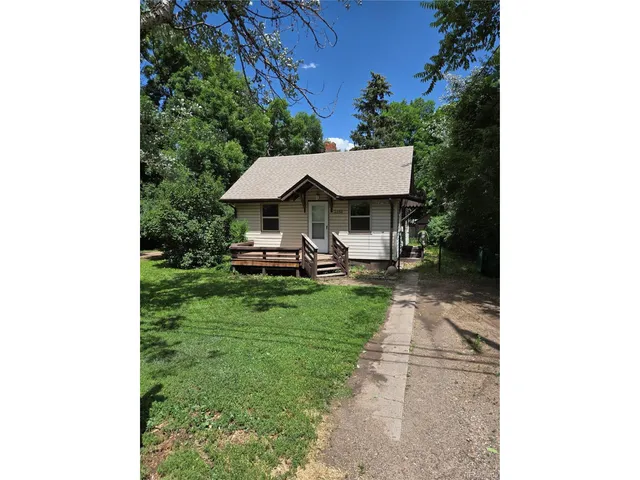 a view of a patio with table and chairs under an umbrella