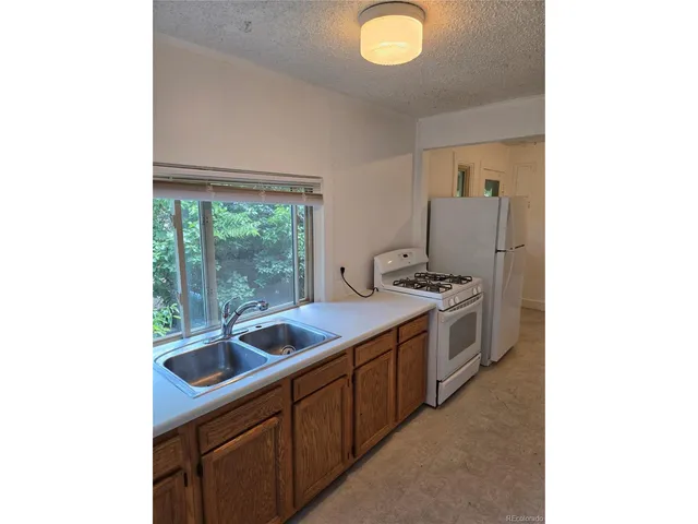 a kitchen with a sink and large window