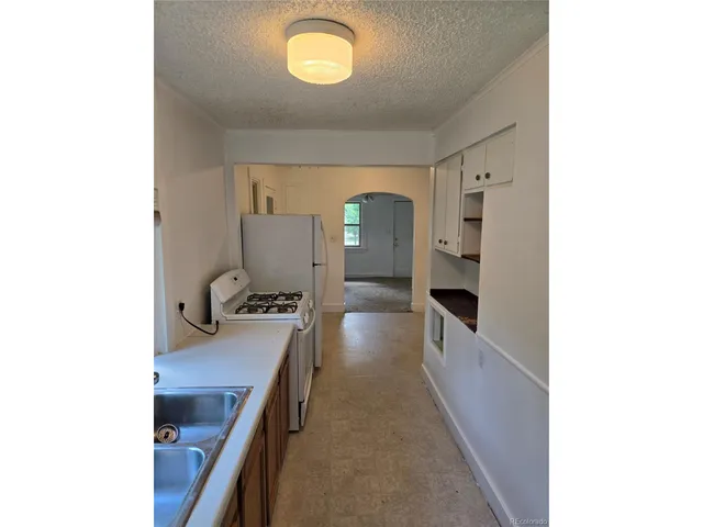 a kitchen with a sink and a stove