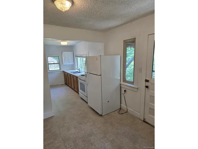 a kitchen with refrigerator and window