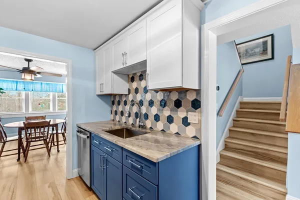 a kitchen with stainless steel appliances granite countertop a stove and a wooden cabinets