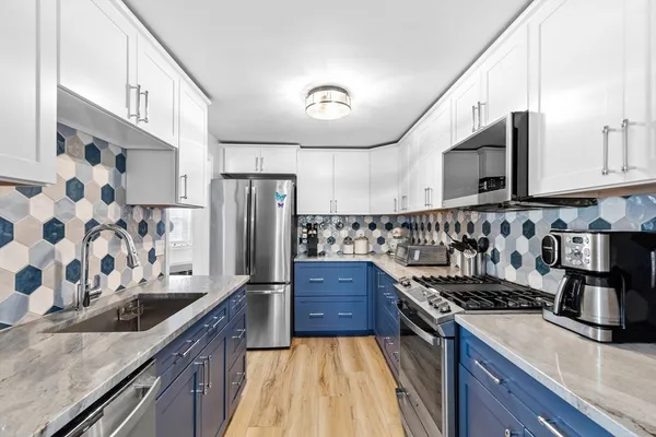a kitchen with granite countertop a stove and a sink