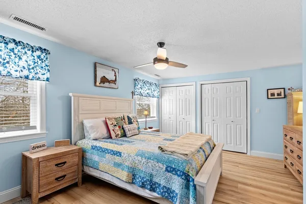 a bedroom with a bed a dresser and a window