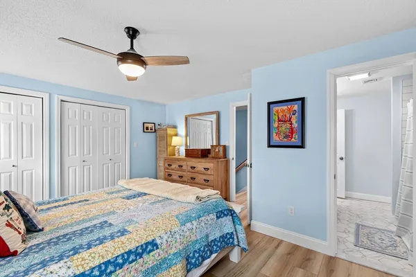 a bedroom with a large bed and a chandelier