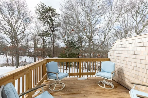 a view of a chair and tables on the roof deck