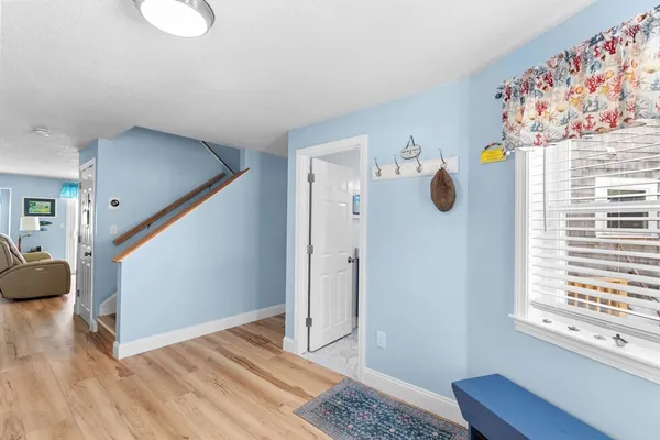 a view of an entryway with wooden floor