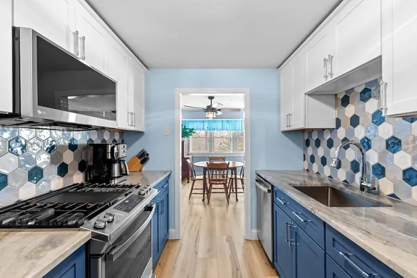 a kitchen with granite countertop a stove and a sink