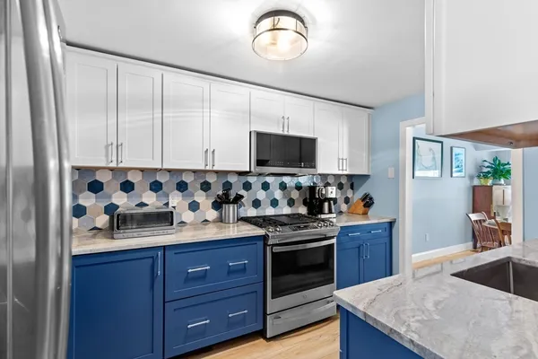 a kitchen with granite countertop a sink and a stove top oven