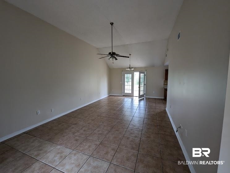 12971 Labradors Run Foley, AL 36535 - Photo 4 of 23 Open-concept living space featuring vaulted ceilings, ceiling fans, and large format tile flooring