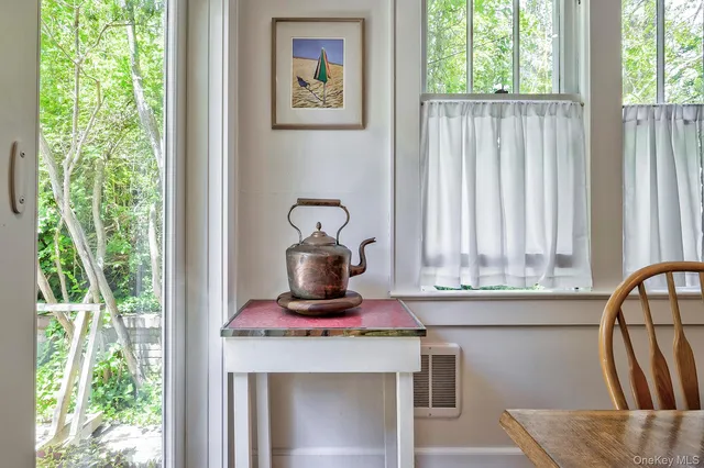 a kitchen with a stove a sink and a window