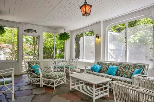a living room with furniture and a floor to ceiling window