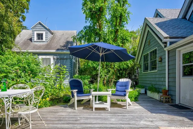 a patio with a table and chairs under an umbrella