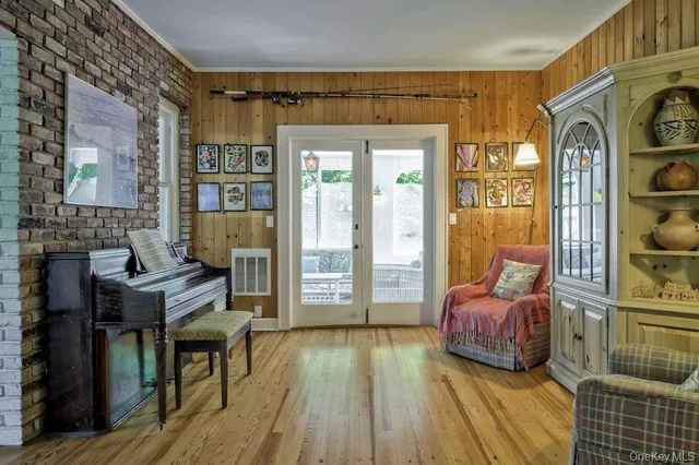 a living room with furniture fireplace and wooden floor