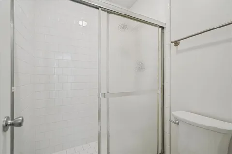 a bathroom with a shower and a toilet