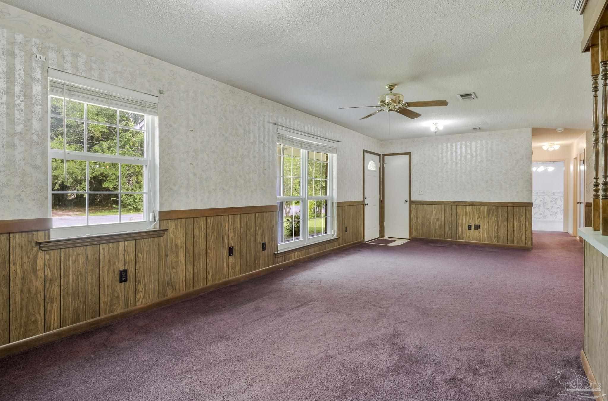 4411 Pace Lane Pace, FL 32571 - Photo 52 of 68 an empty room with a window and a kitchen