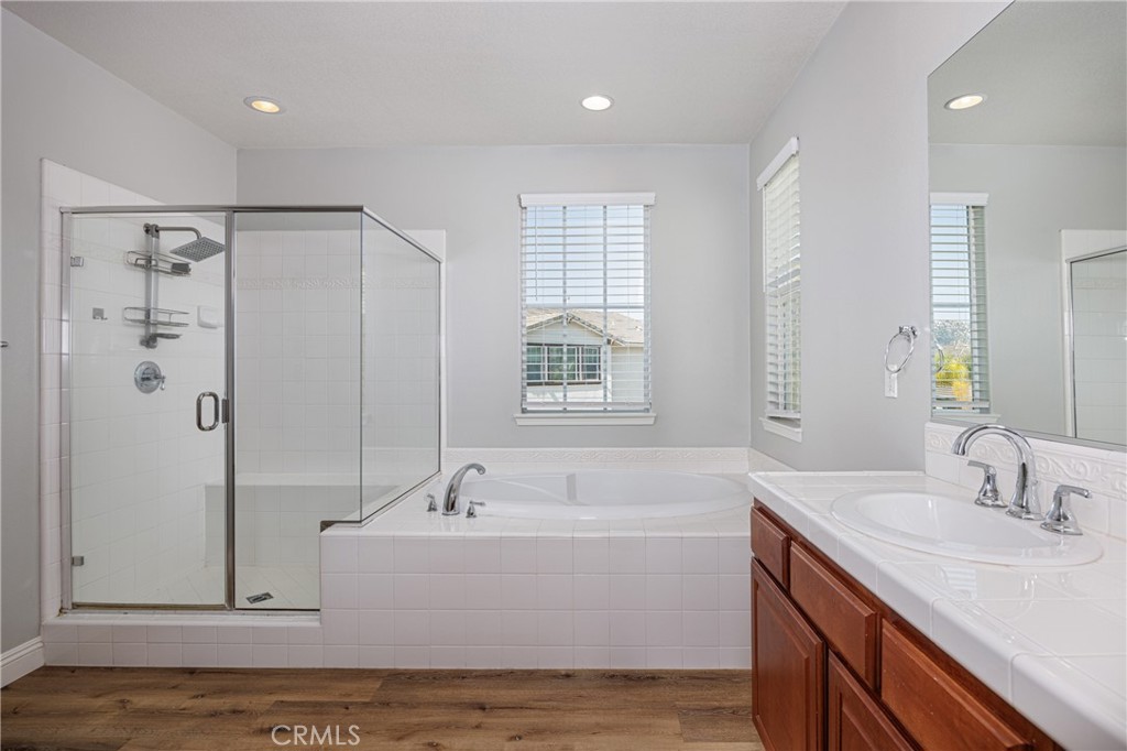 32056 Red Mountain Way Temecula, CA 92592 - Photo 13 of 28 a bathroom with a tub a sink and mirror