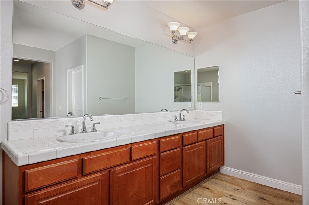 32056 Red Mountain Way Temecula, CA 92592 - Photo 15 of 28 a bathroom with a sink and a mirror