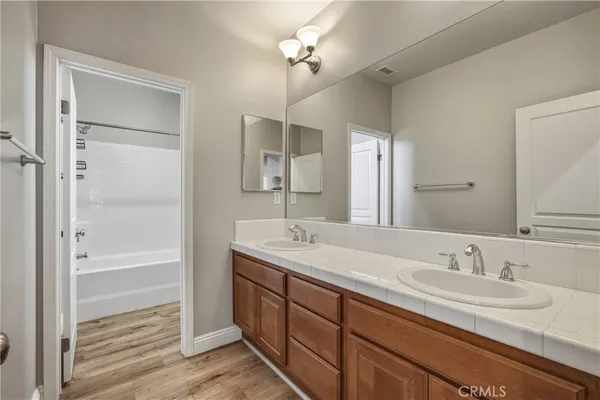 a bathroom with a sink double vanity and a mirror