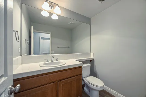 a bathroom with a sink toilet and a mirror