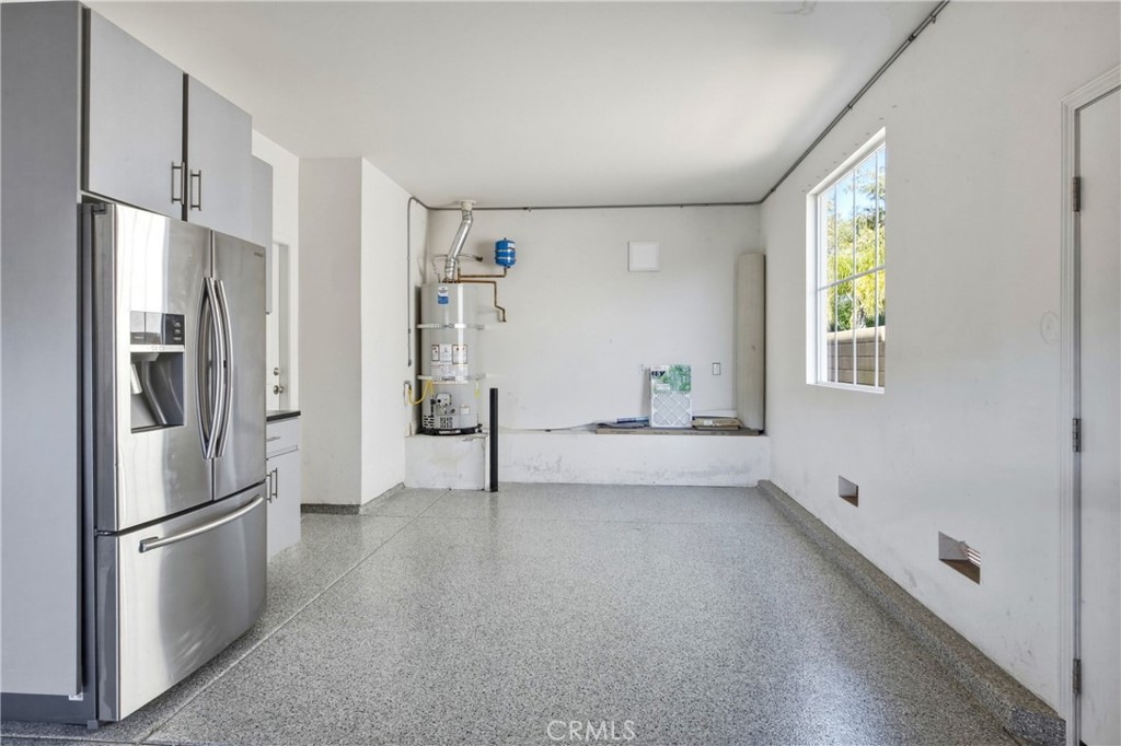 32056 Red Mountain Way Temecula, CA 92592 - Photo 23 of 28 a kitchen with stainless steel appliances a refrigerator sink and white cabinets