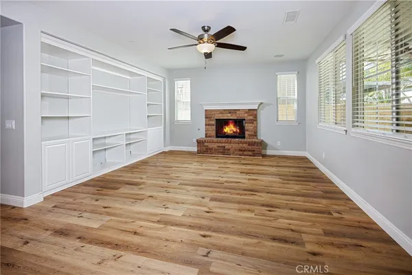 a view of empty room with a fireplace and fan