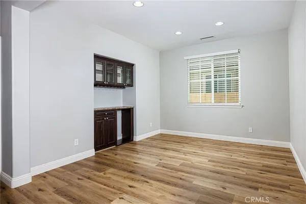 a view of an empty room with a window and a fireplace