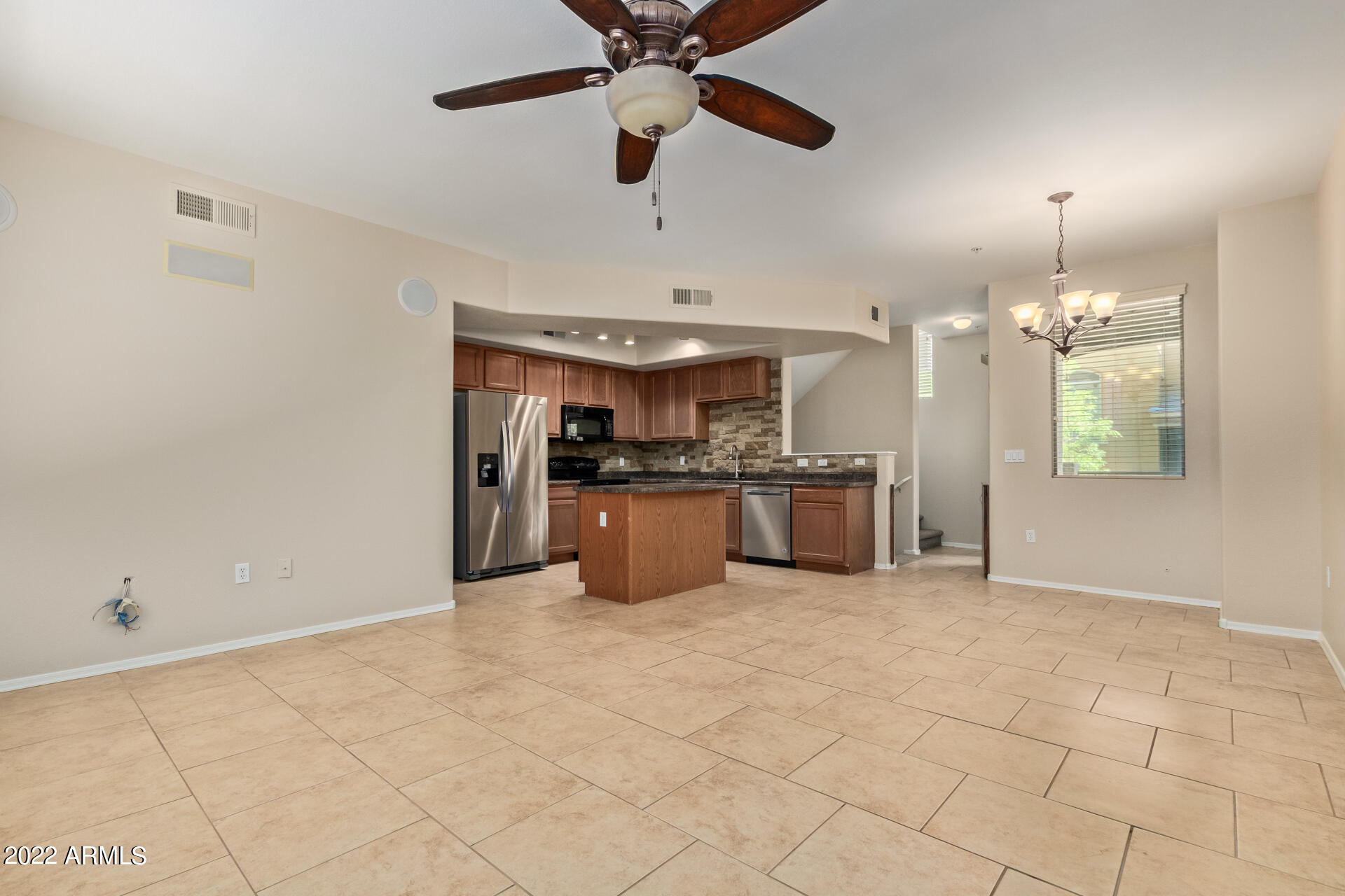 2150 West Alameda Road, Unit 1391 Phoenix, AZ 85085 - Photo 12 of 63 a kitchen with stainless steel appliances kitchen island granite countertop a sink cabinets and window