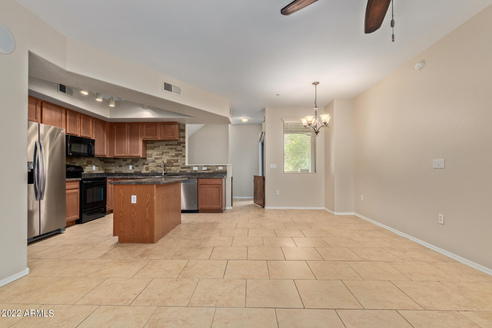 2150 West Alameda Road, Unit 1391 Phoenix, AZ 85085 - Photo 13 of 63 a large kitchen with cabinets and stainless steel appliances