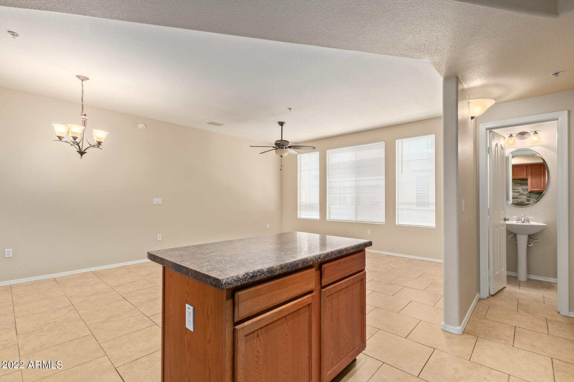2150 West Alameda Road, Unit 1391 Phoenix, AZ 85085 - Photo 21 of 63 a bathroom with a granite countertop sink and a mirror