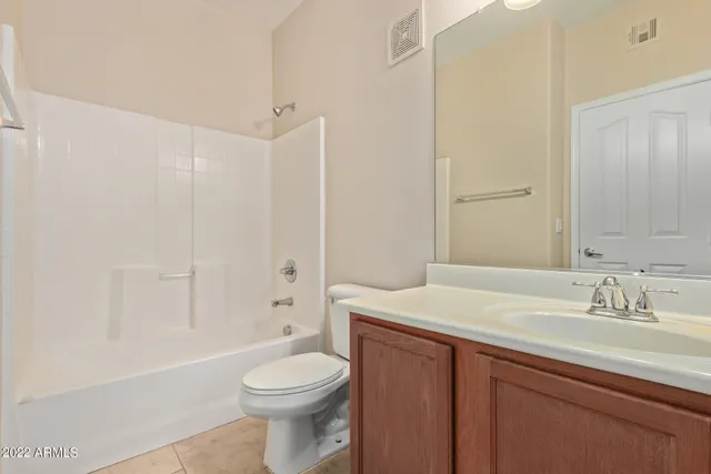 an empty room with closet and windows