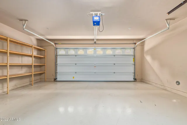 a front view of a house with garden and sitting area