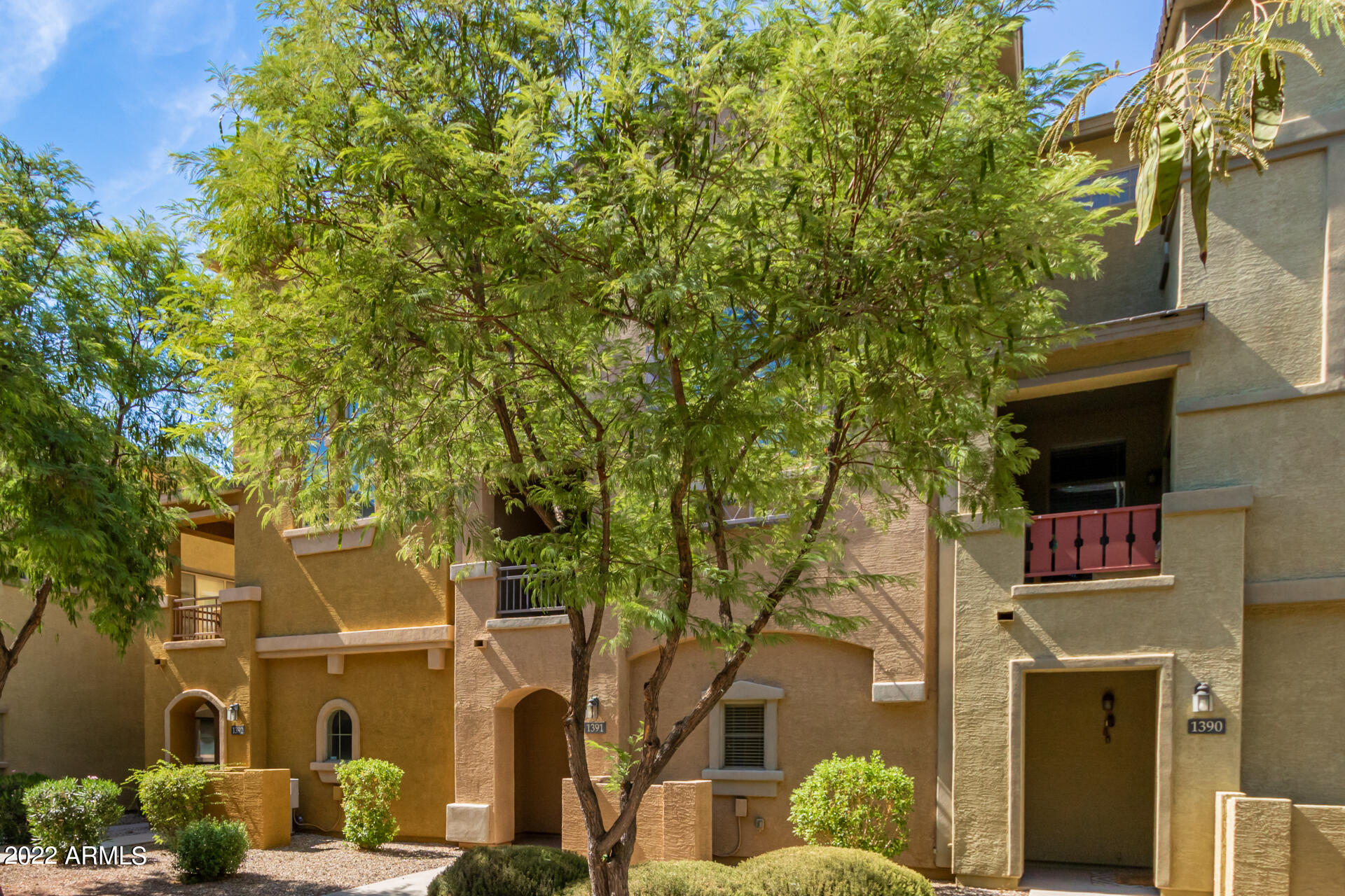 2150 West Alameda Road, Unit 1391 Phoenix, AZ 85085 - Photo 6 of 63 front view of a brick house with a large tree