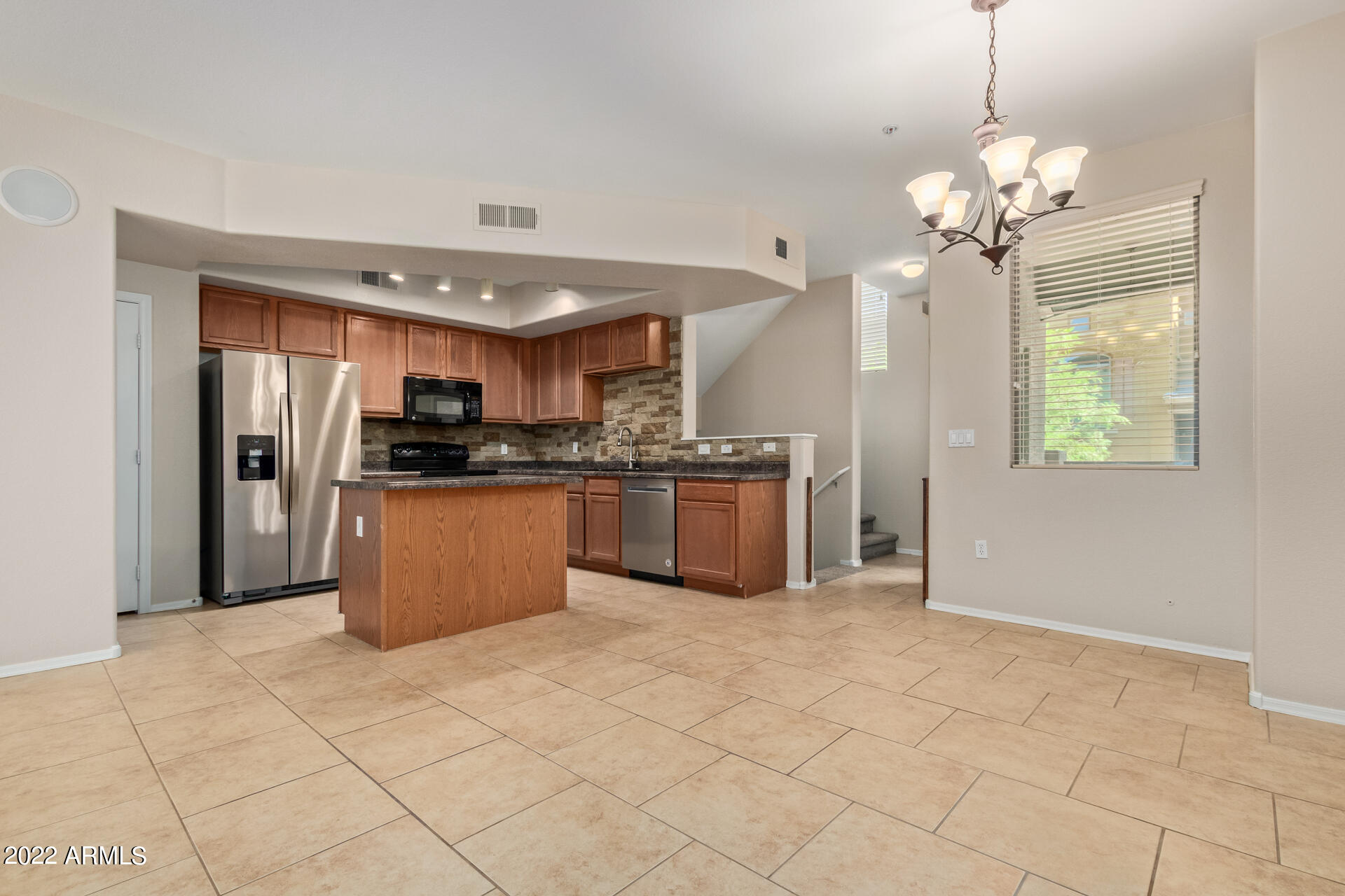 2150 West Alameda Road, Unit 1391 Phoenix, AZ 85085 - Photo 9 of 63 a kitchen with stainless steel appliances granite countertop a stove cabinets and refrigerator