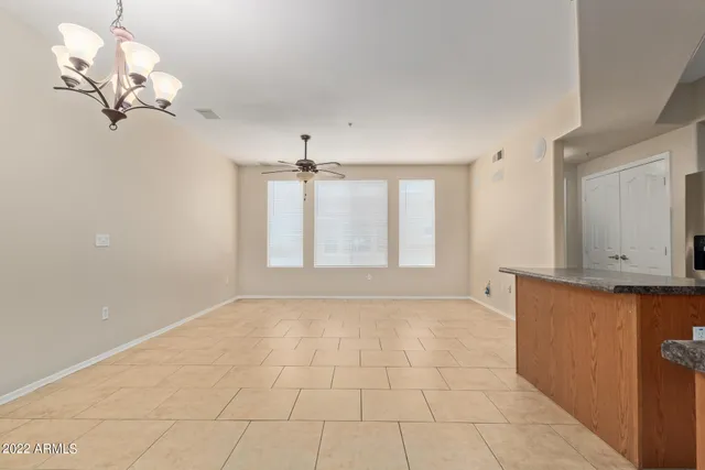 a kitchen with stainless steel appliances kitchen island granite countertop a sink cabinets and window