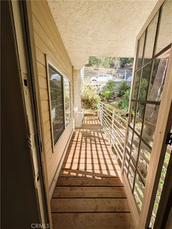 a living room with a large window and a glass door shower
