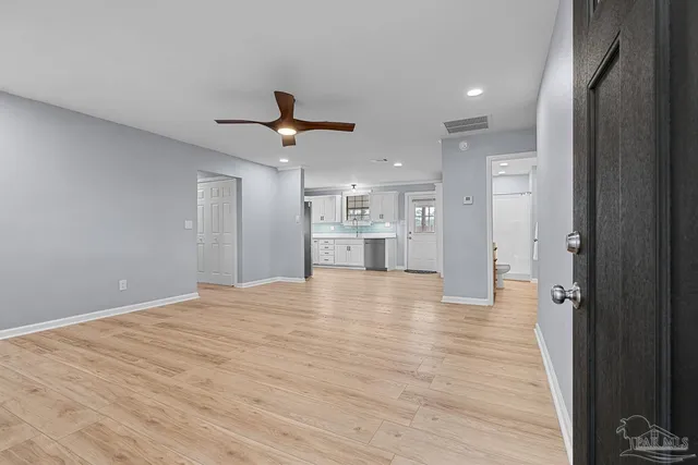 a view of a kitchen with a sink and a refrigerator