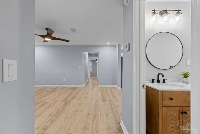a bedroom with a sink and a mirror
