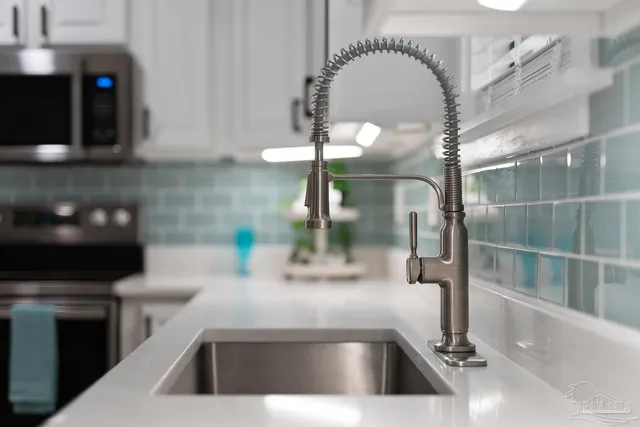 a kitchen with a sink and a mirror
