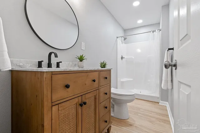 a bathroom with a sink toilet and shower