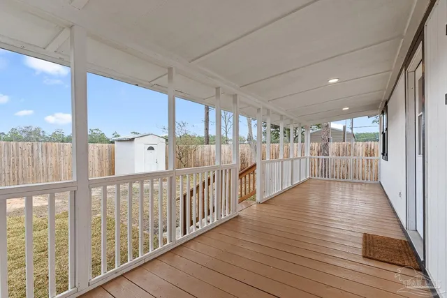 a view of a porch with wooden floor