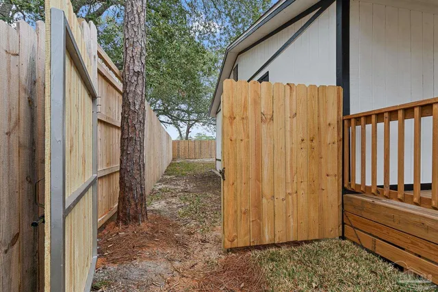 a view of balcony with wooden floor and fence