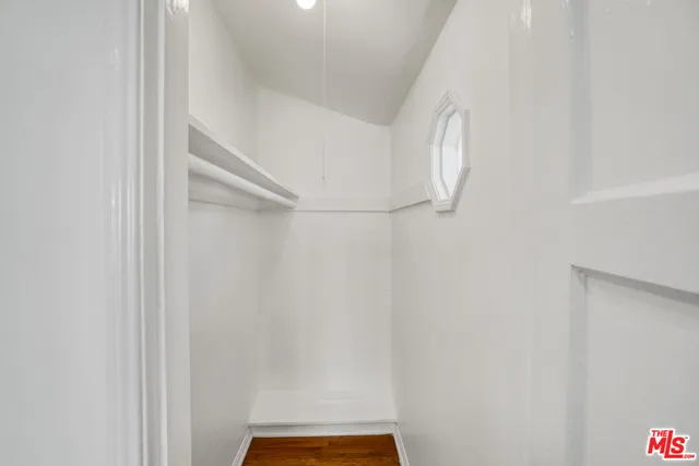 a bathroom with a granite countertop sink a mirror and a bathtub