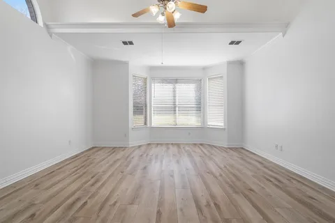 a bedroom with a bed and a chair