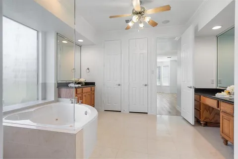 a bathroom with a granite countertop toilet a sink and bathtub