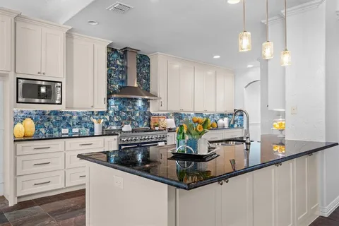 a kitchen with stainless steel appliances granite countertop a stove and a cabinets