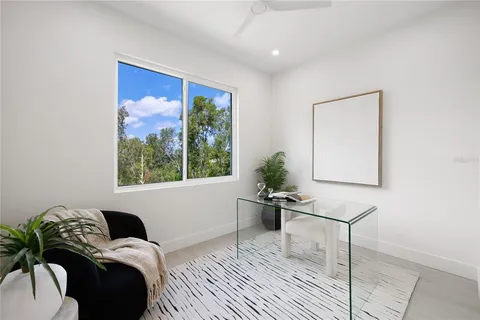 a bedroom with bed and a potted plant